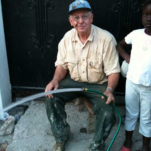 Company Owner Holding A Water Hose — Traverse City, MI — Berg Well Drilling