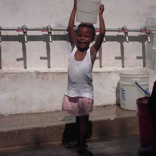 Kid Carrying A Small Pail Of Water — Traverse City, MI — Berg Well Drilling