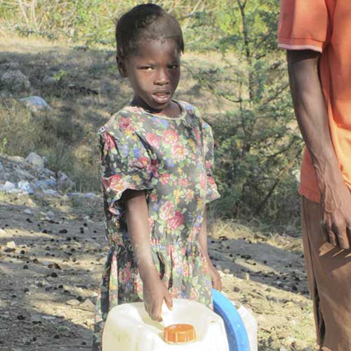 Kid Carrying Water Containers — Traverse City, MI — Berg Well Drilling