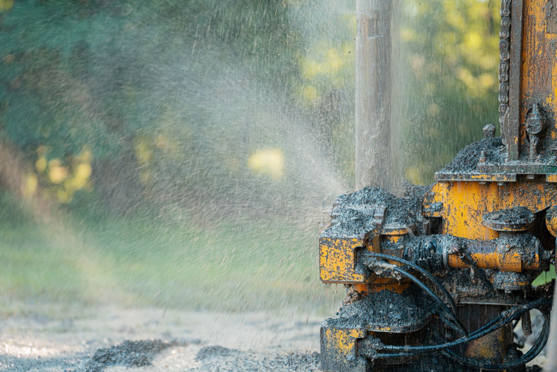 Close-up of a well drilling rig boring down into the earth