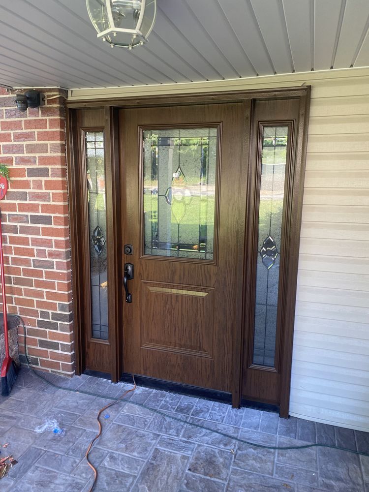 Brown front door with stained glass panels.