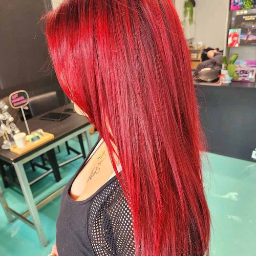 A Woman With Long Red Hair Is Standing In A Room — MLB Hair In  Smithfield, QLD