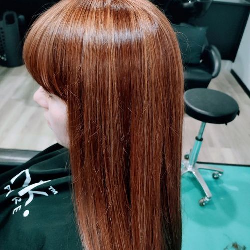 A Woman With Long Hair Is Sitting In A Chair In A Salon — MLB Hair In  Smithfield, QLD