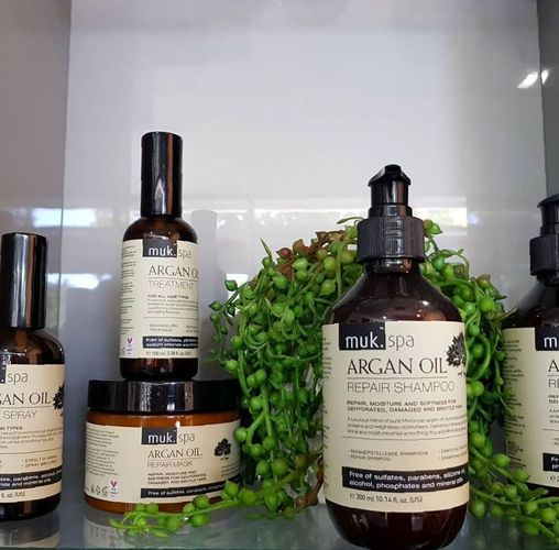 A Row Of Bottles On A Shelf — MLB Hair In  Smithfield, QLD