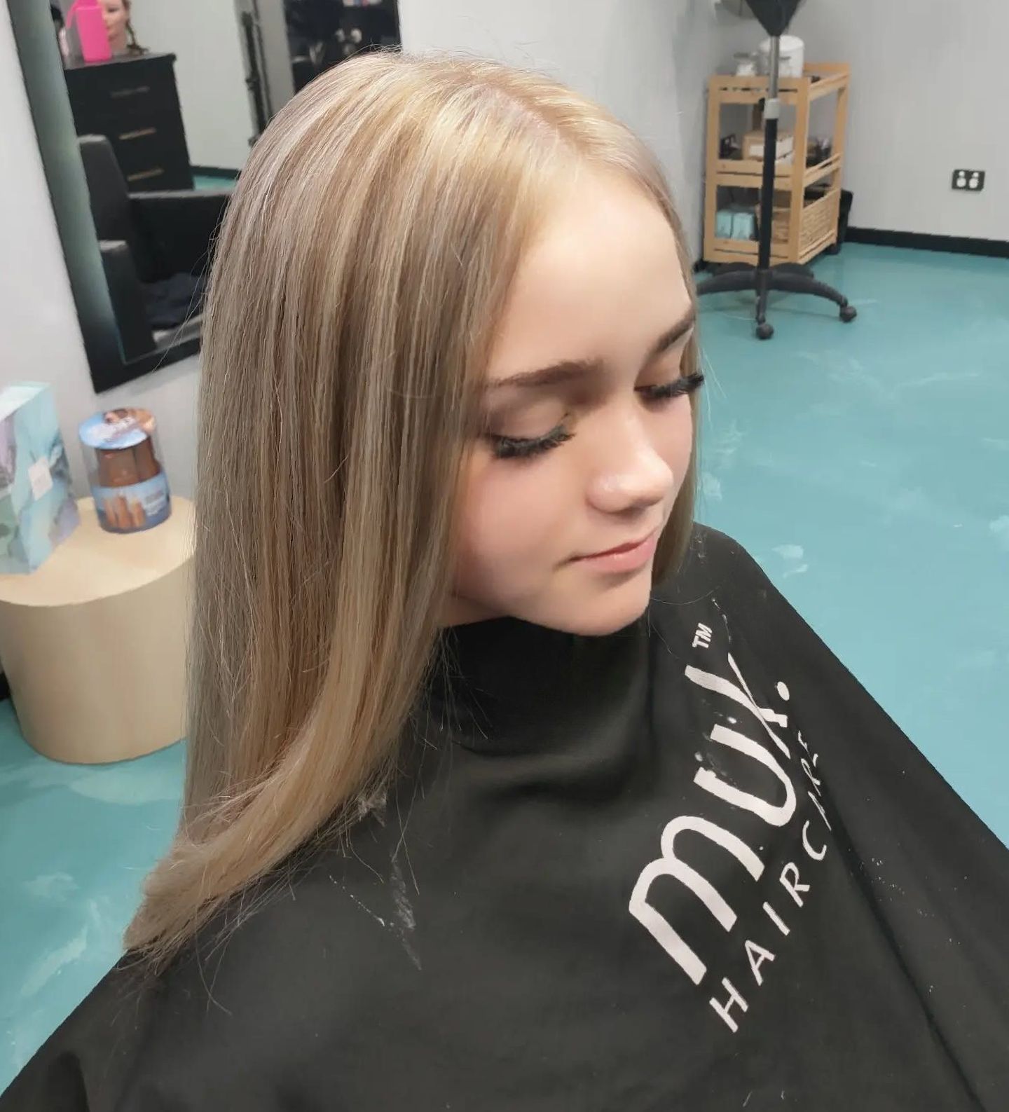 A Woman In A Black Cape Is Getting Her Hair Dyed — MLB Hair In  Smithfield, QLD