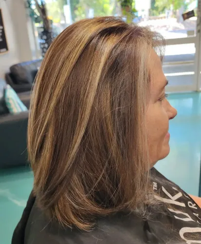 A Woman Is Getting Her Hair Done In A Salon — MLB Hair In  Smithfield, QLD