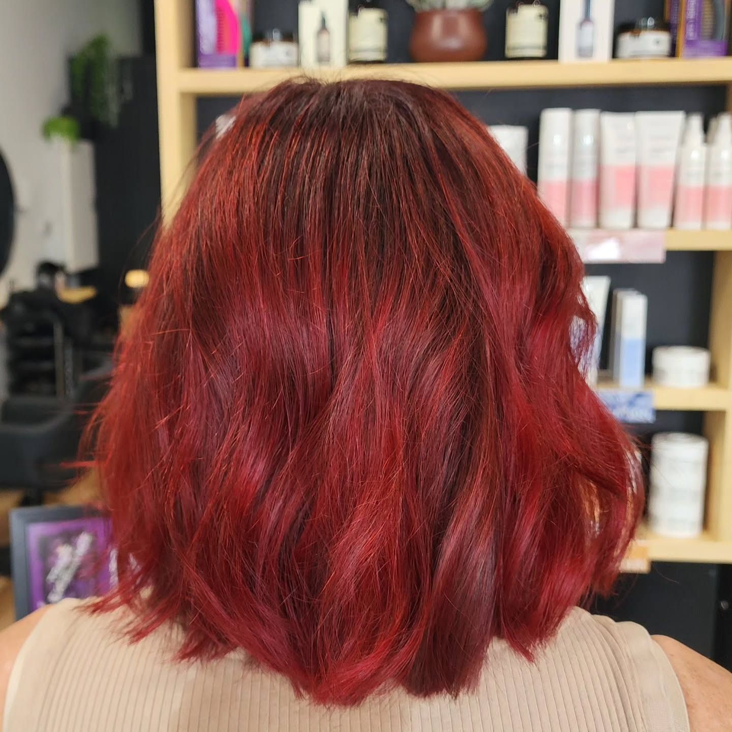 A Woman With Pink And Green Hair Is Smiling In A Salon — MLB Hair In  Smithfield, QLD