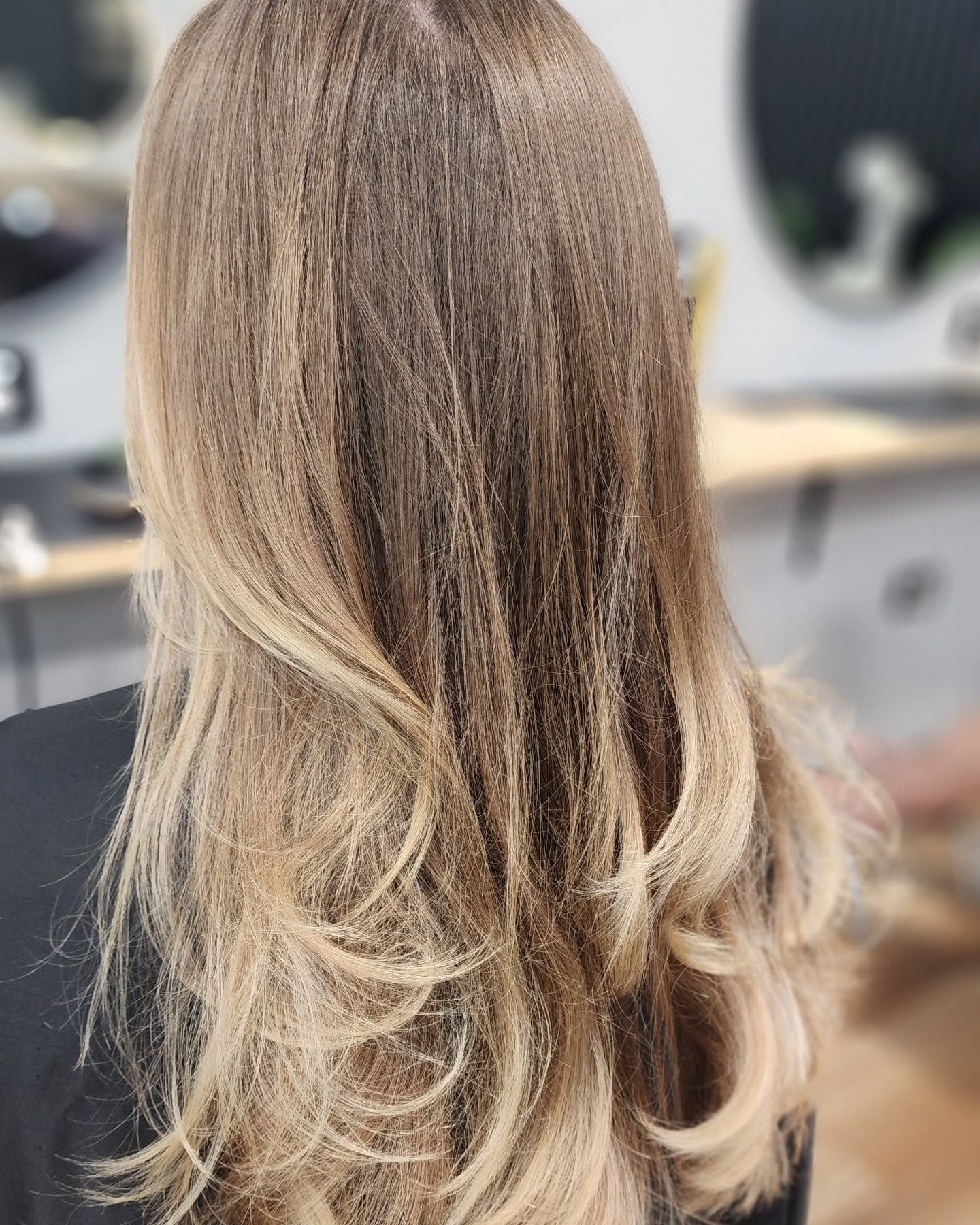 A Woman With Purple Hair Is Sitting In A Chair In A Salon — MLB Hair In  Smithfield, QLD