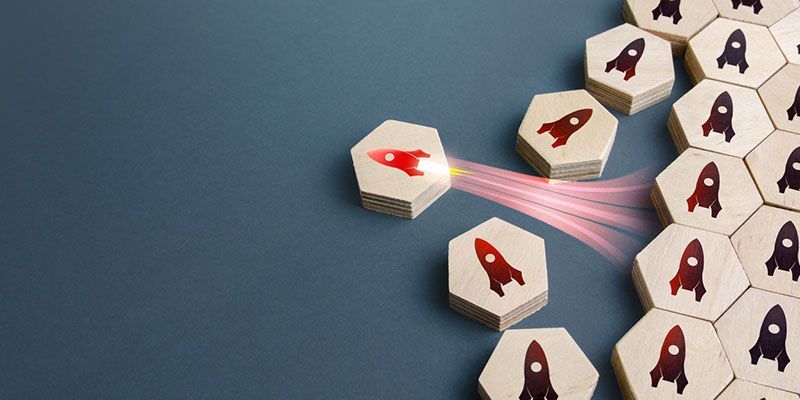 A group of wooden blocks with rockets on them on a blue background.