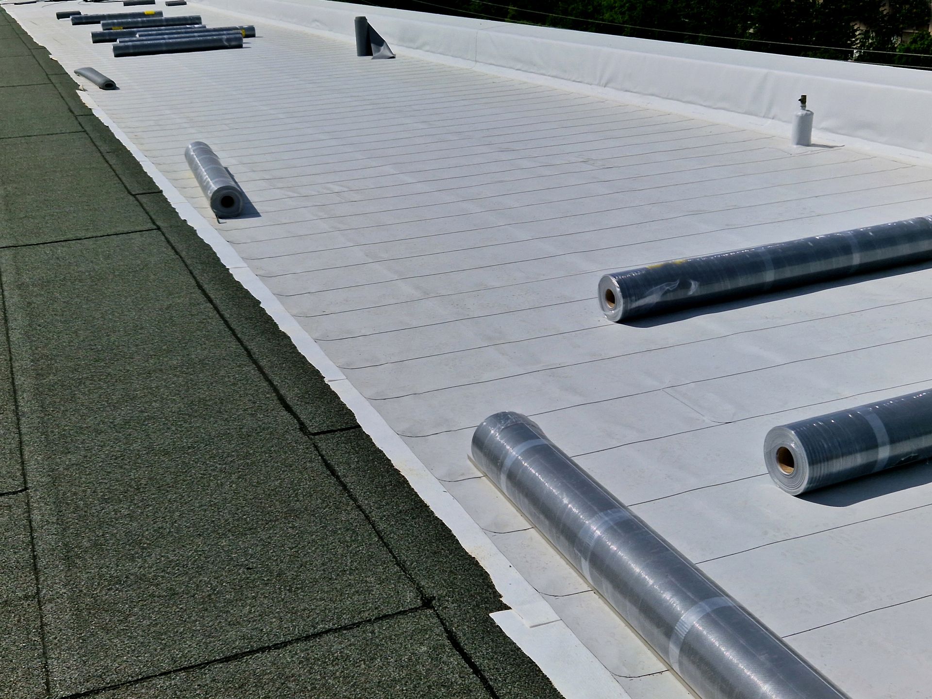 Commercial roof installation in progress. Commercial roof installation in progress.