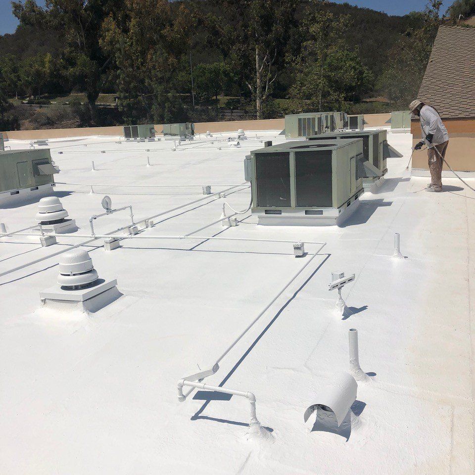 A man is painting the roof of a building