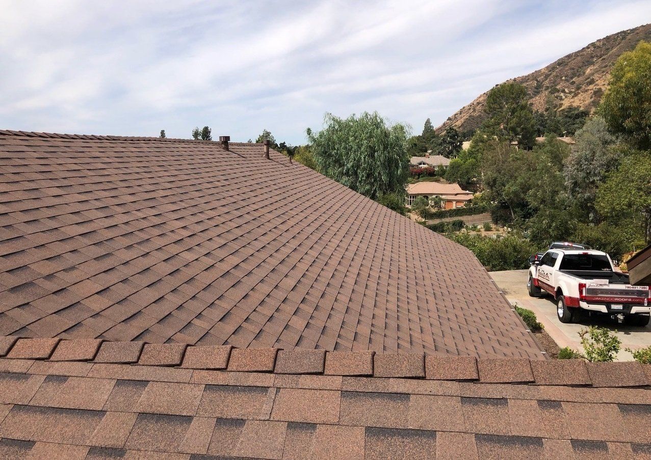 A red truck is parked on the roof of a house.