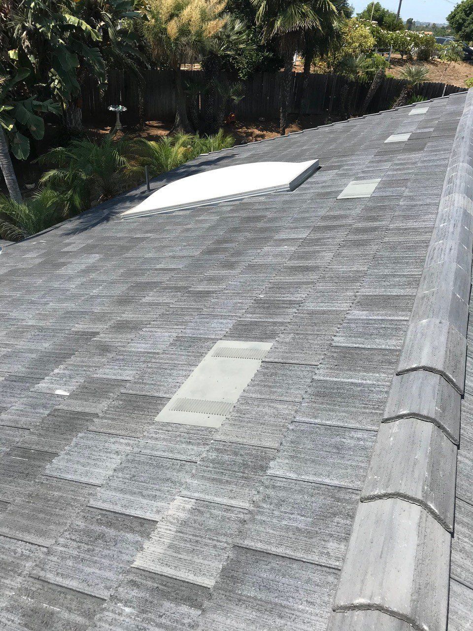 A gray tiled roof with a white square in the middle of it.