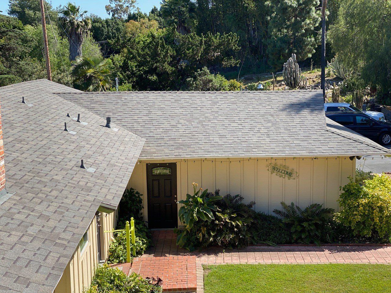 An aerial view of a house with a black roof