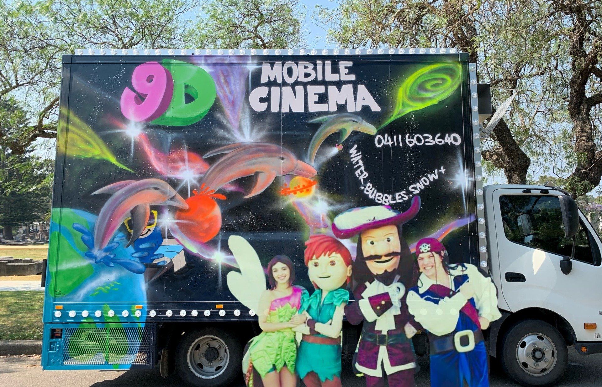 A mobile cinema truck with cartoon characters on it