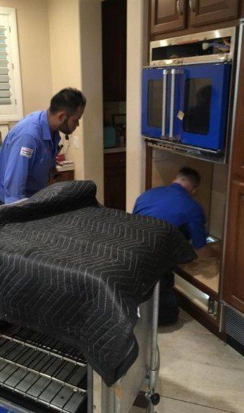 Men repairing washing machine