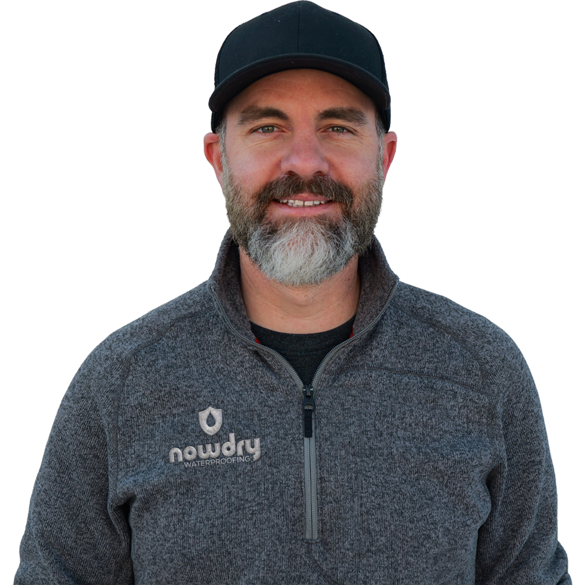 Smiling man in a black cap and gray zip-up jacket against a white background