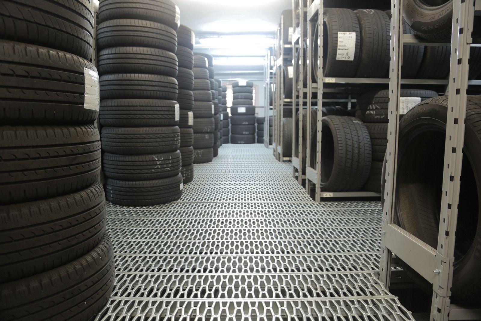 A tire balancing machine with a monitor on top of it.