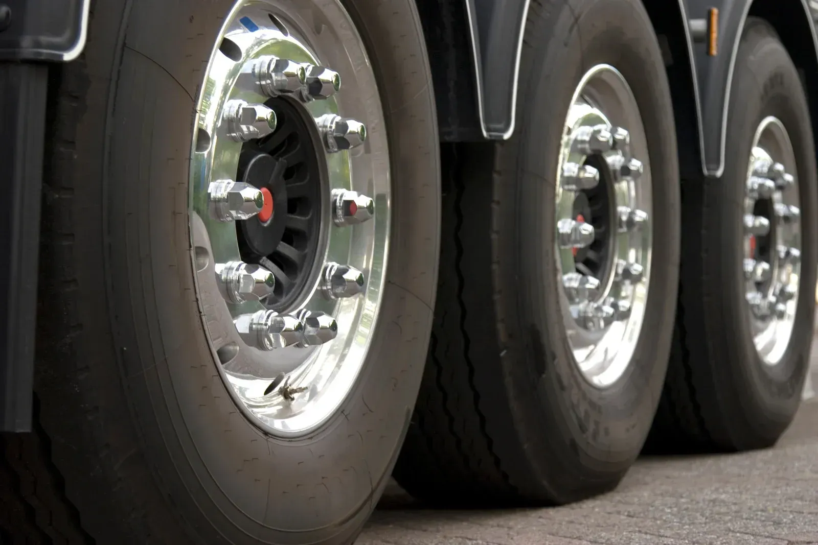 A close up of a truck 's wheels and tires