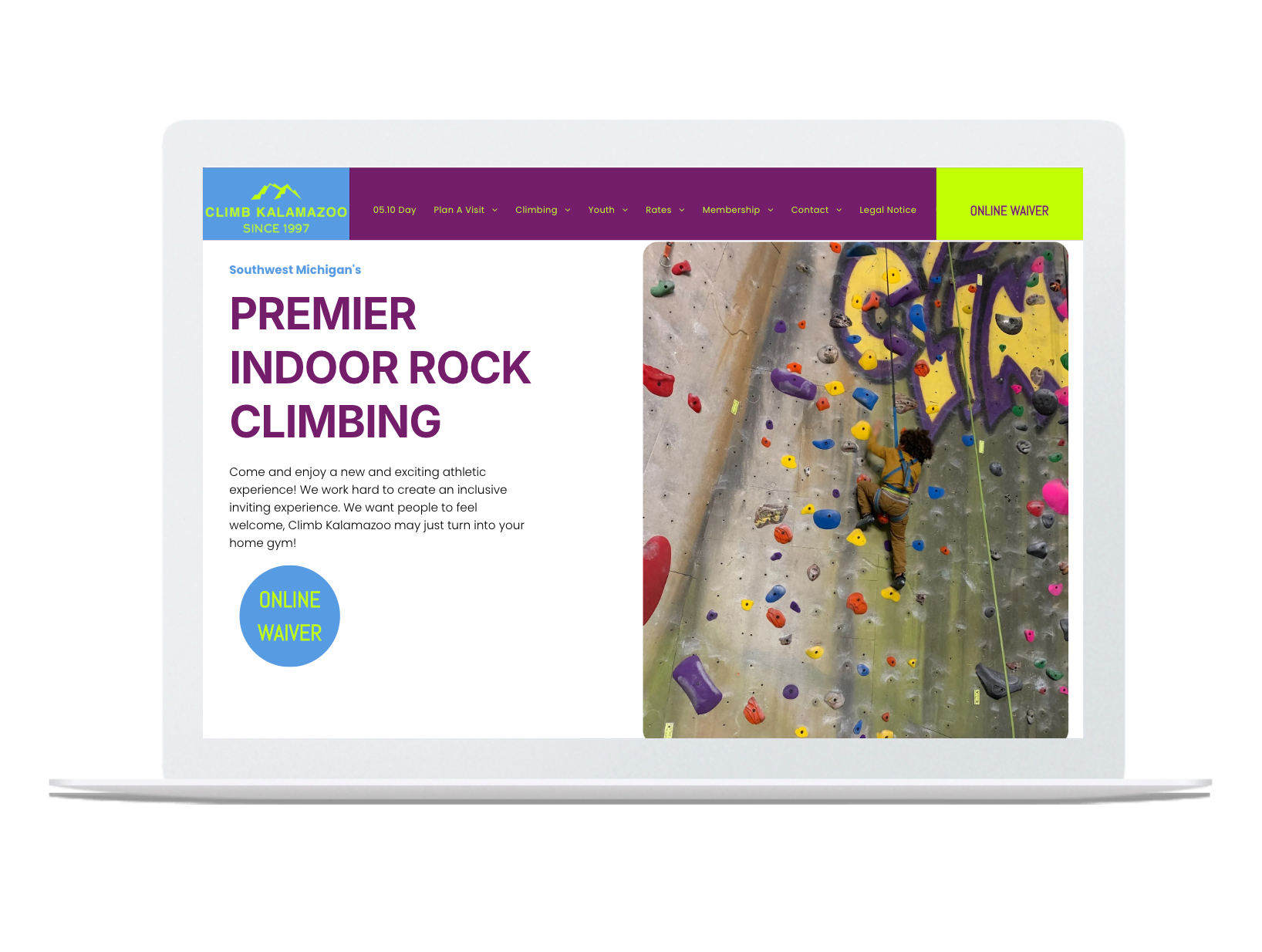 A laptop screen shows a website for premier indoor rock climbing.