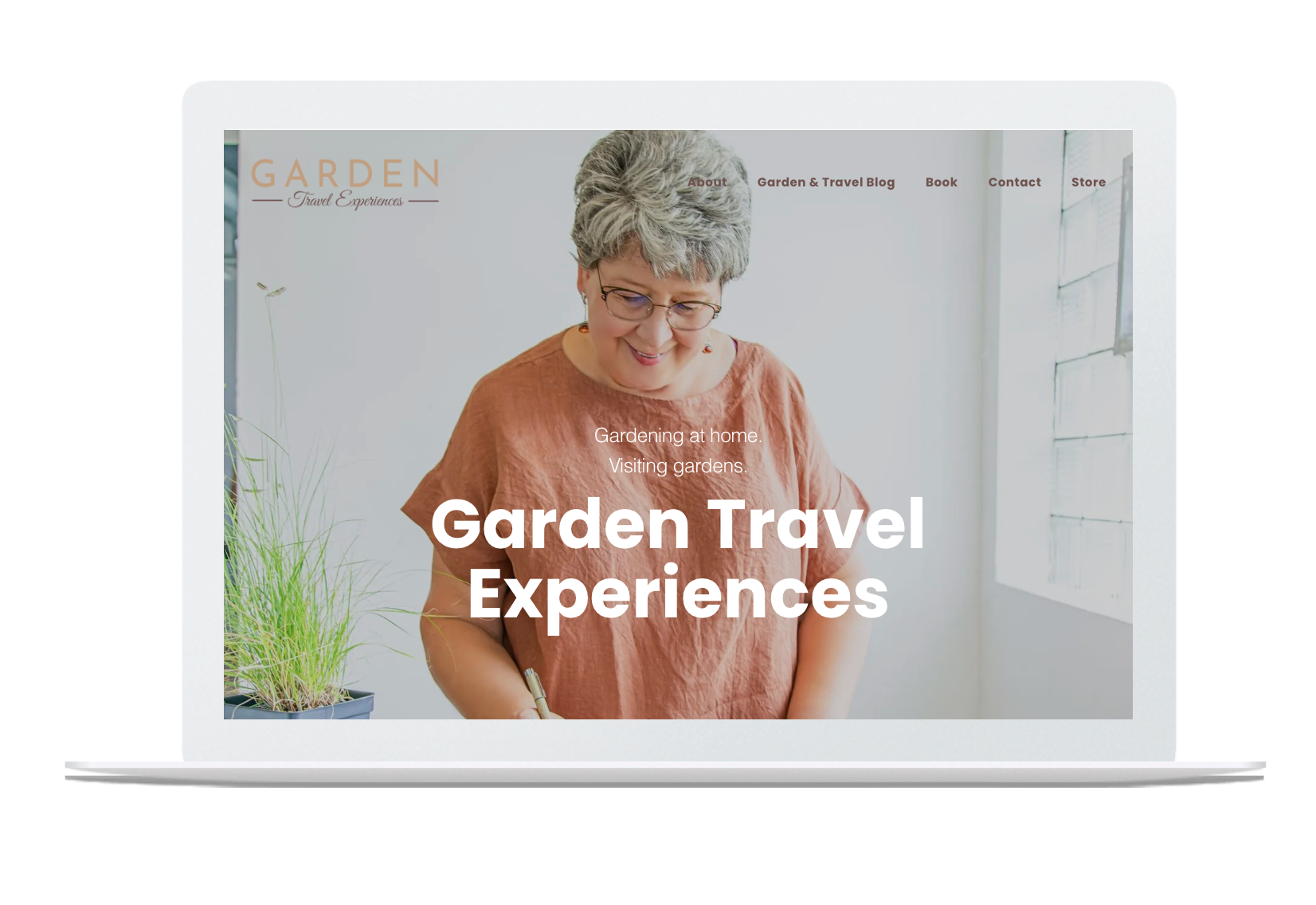 A laptop computer is open to a garden travel experiences website.