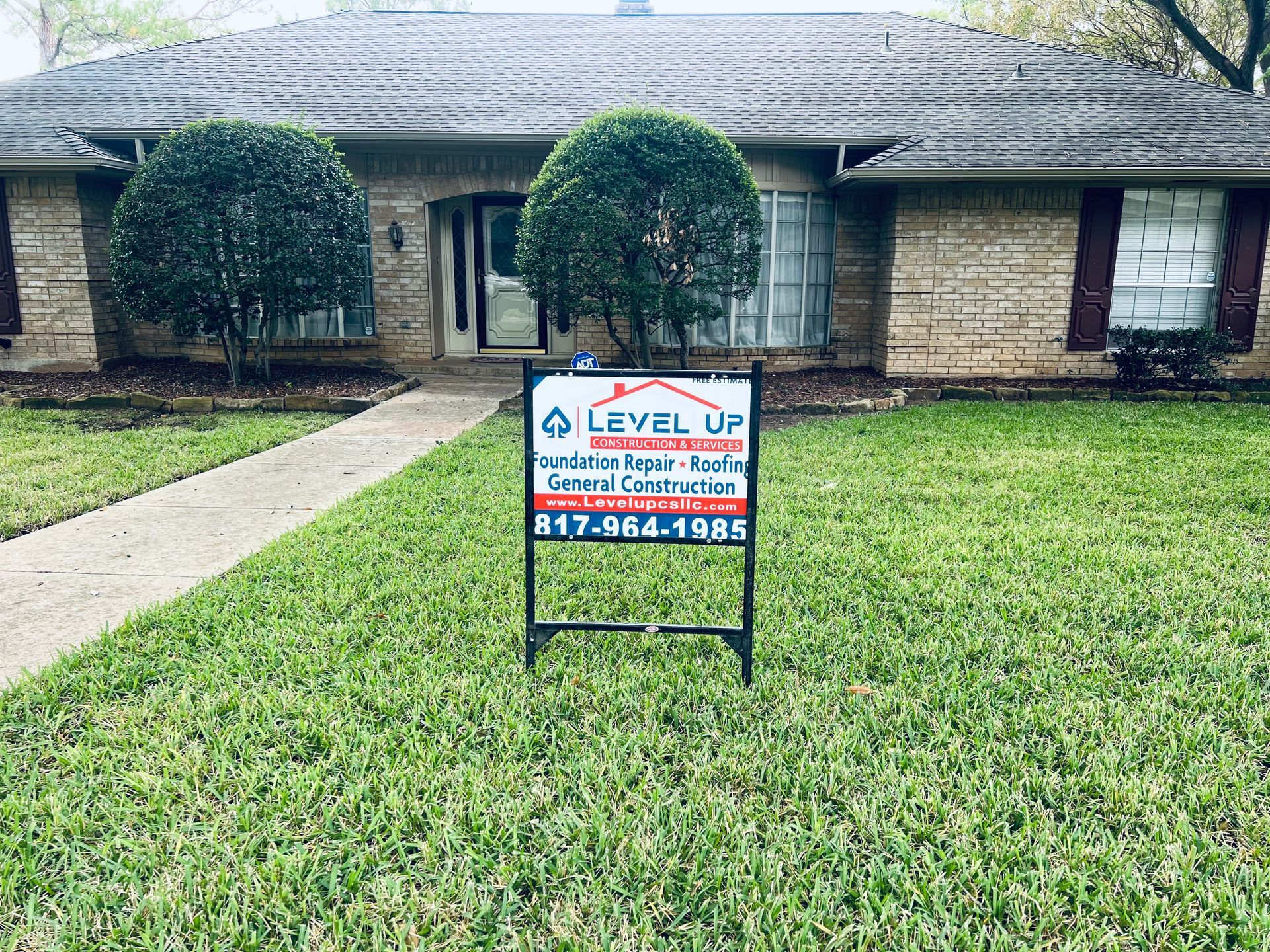 A house with a level up sign in front of it.