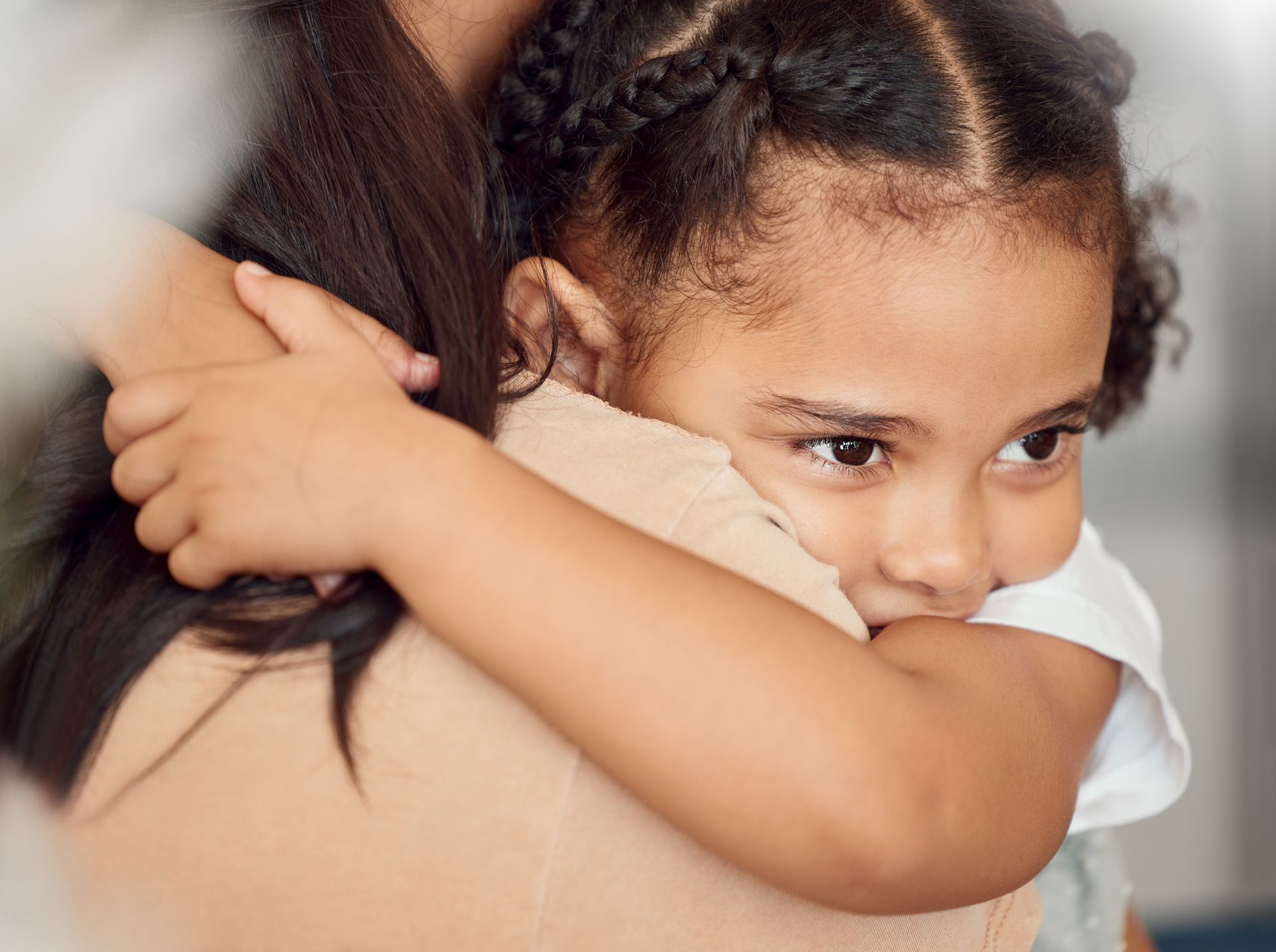 A little girl is hugging her mother.
