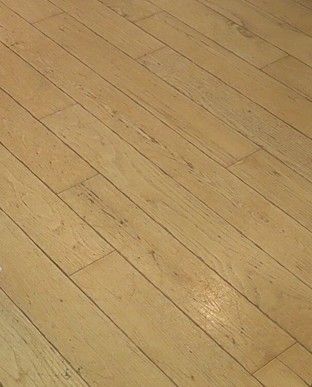 Close-up view of light-colored Hardwood Floor with a natural grain texture.