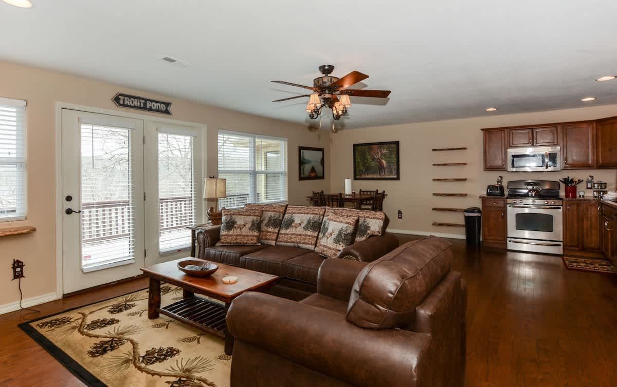 A living room filled with furniture and a ceiling fan.