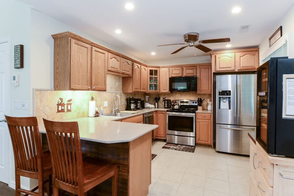 A kitchen with stainless steel appliances and wooden cabinets