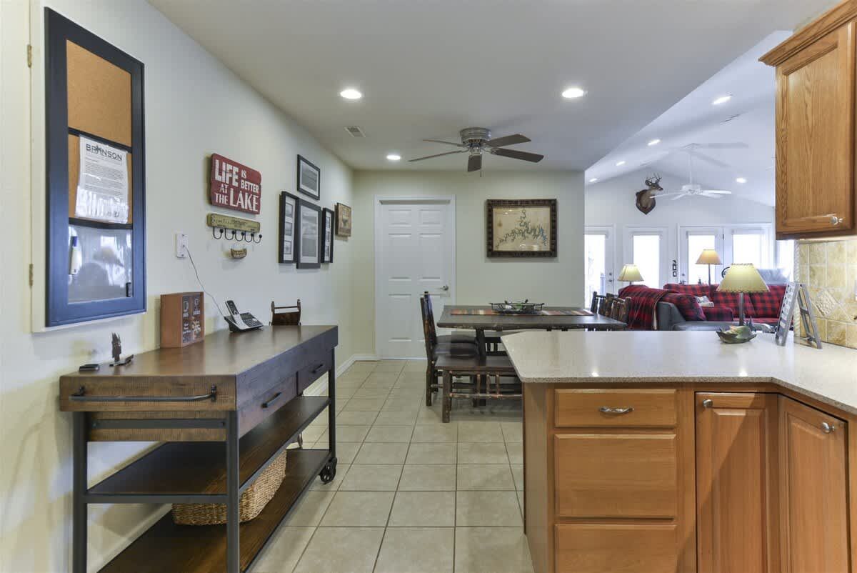 A kitchen with wooden cabinets and a large island