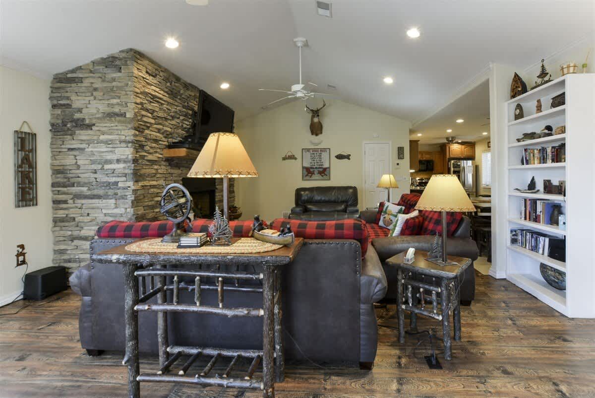 A living room with a lot of furniture and a ceiling fan