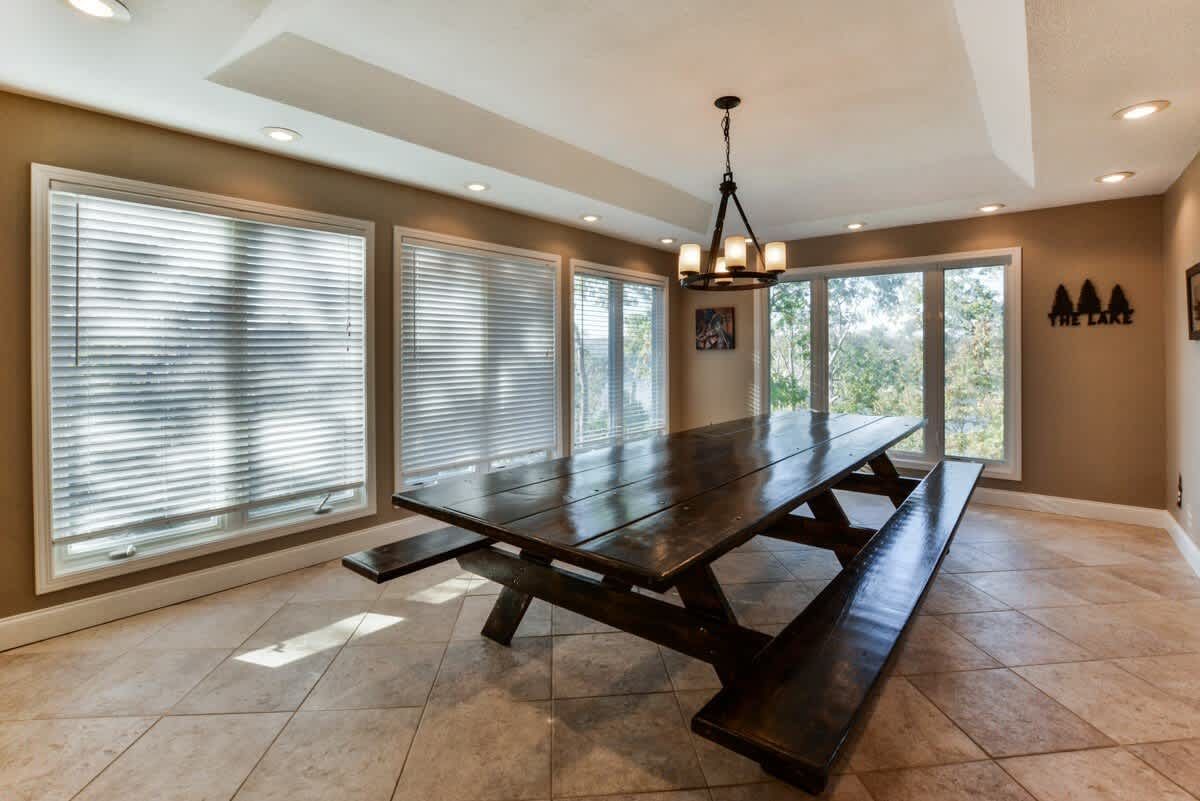 A dining room with a long wooden table and benches