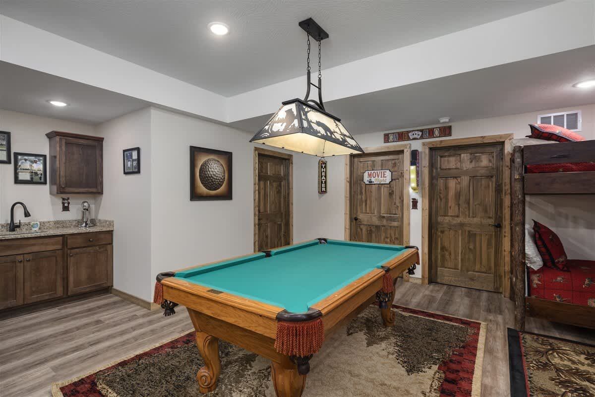 There is a pool table in the middle of the room.
