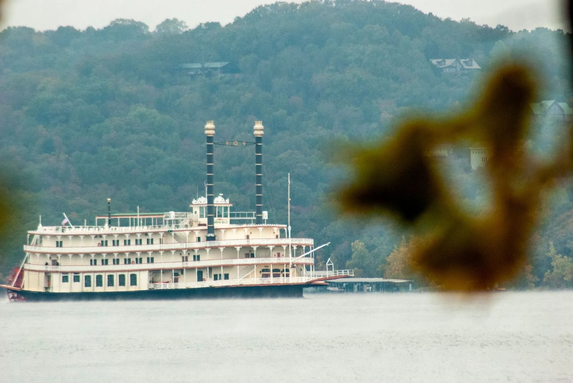 A large white boat is floating on top of a body of water.