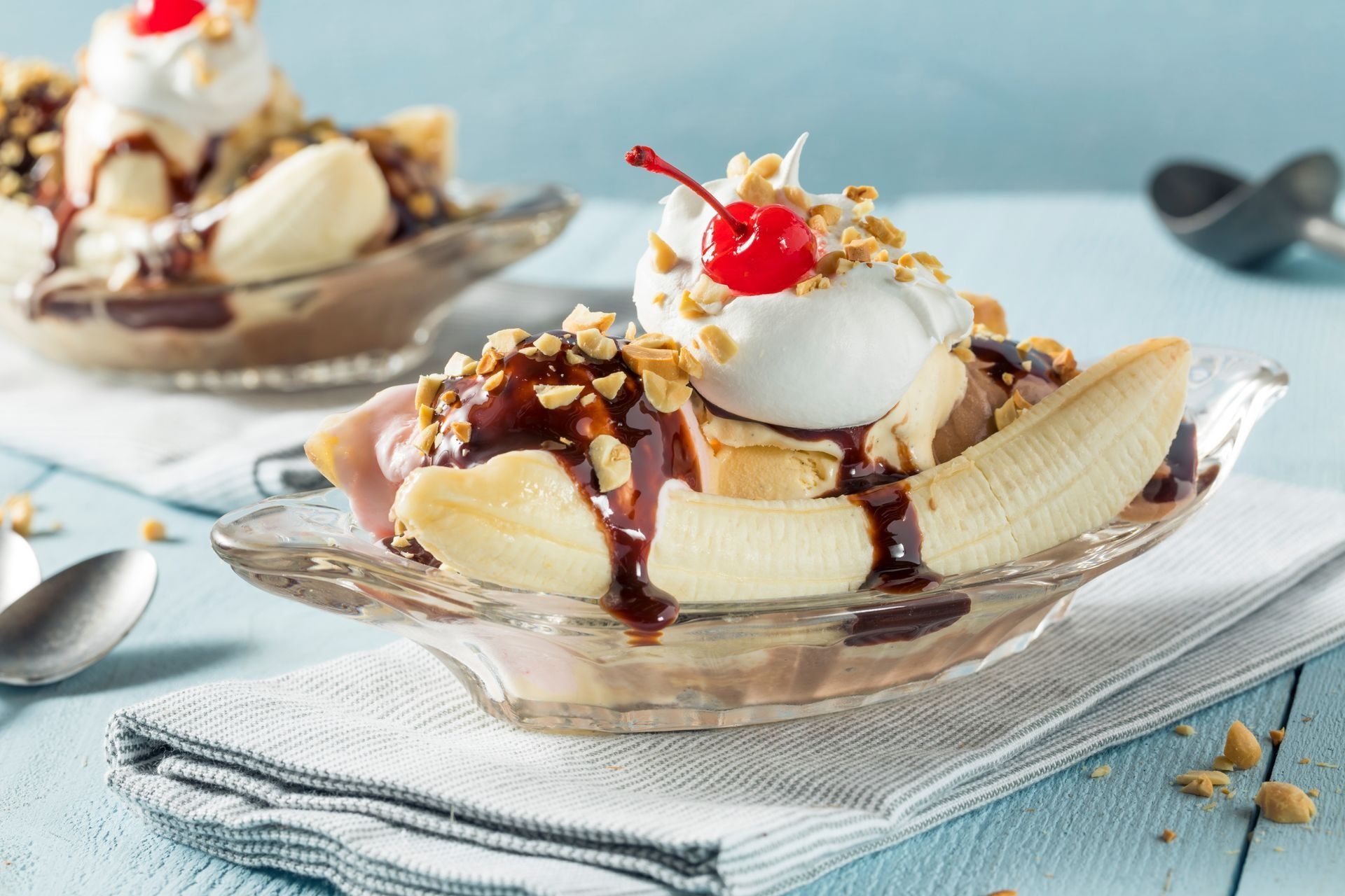 A banana split with whipped cream and a cherry on top.