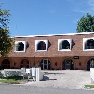 A large brick building with arched windows and arched doors