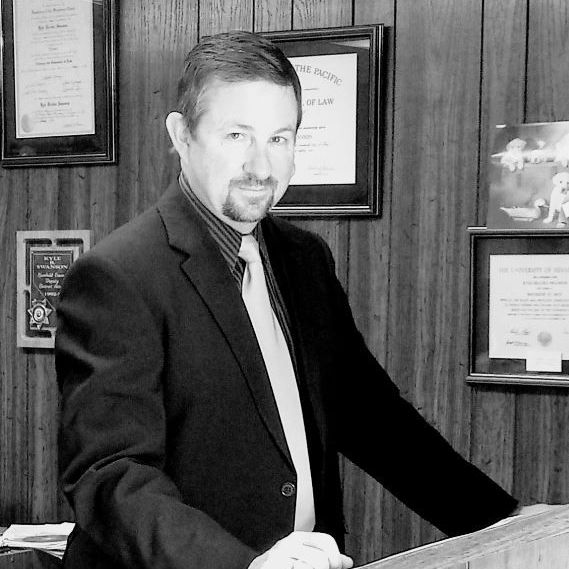 A man in a suit and tie is standing at a podium