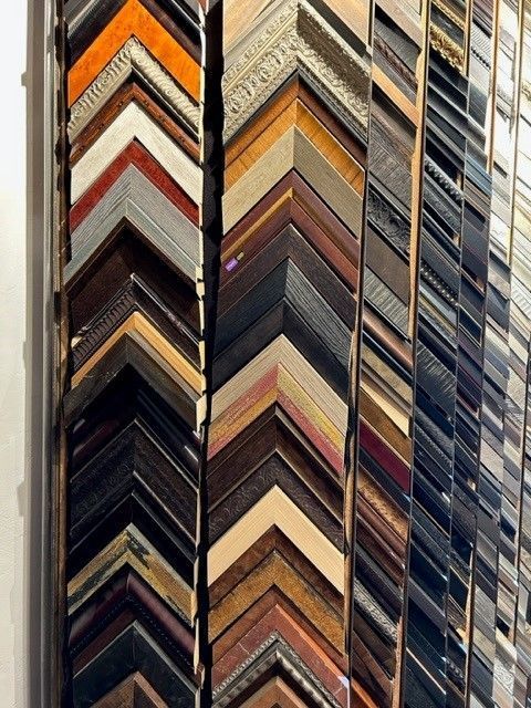 Colorful stacked picture frame corners forming a geometric wall pattern