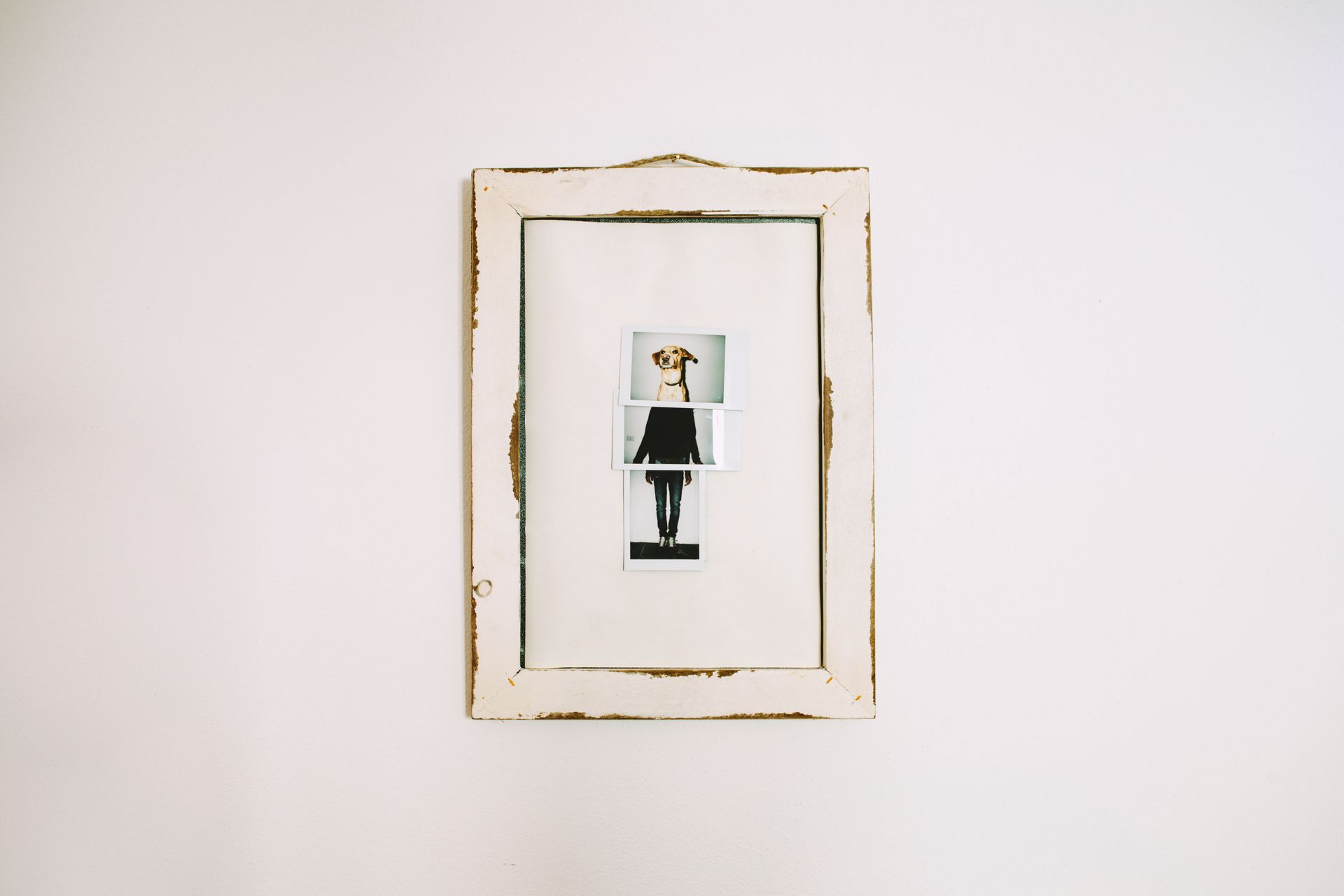 Framed minimalist art with a small figure centered on a white wall