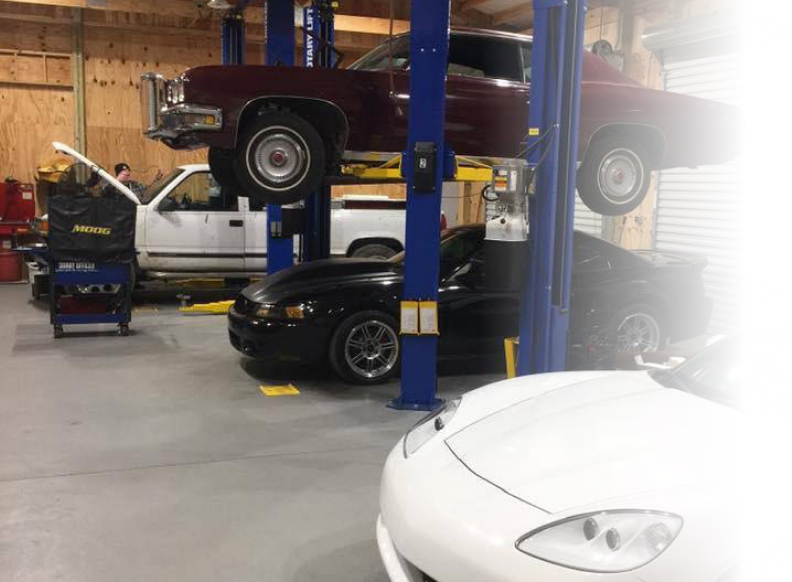 Cars in our garage and on lifts, ready for expert repair | Brake Time Auto Repair