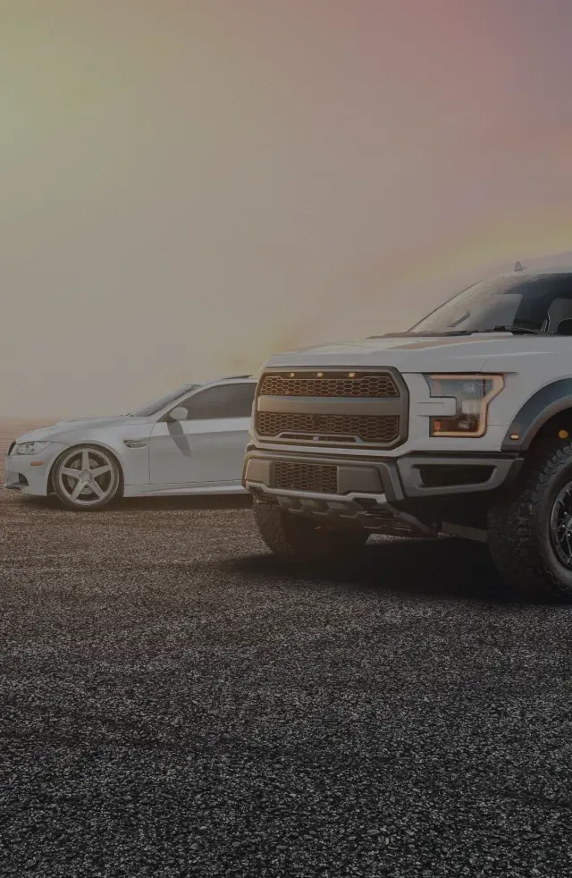 White truck and white car parked outside | Brake Time Auto Repair