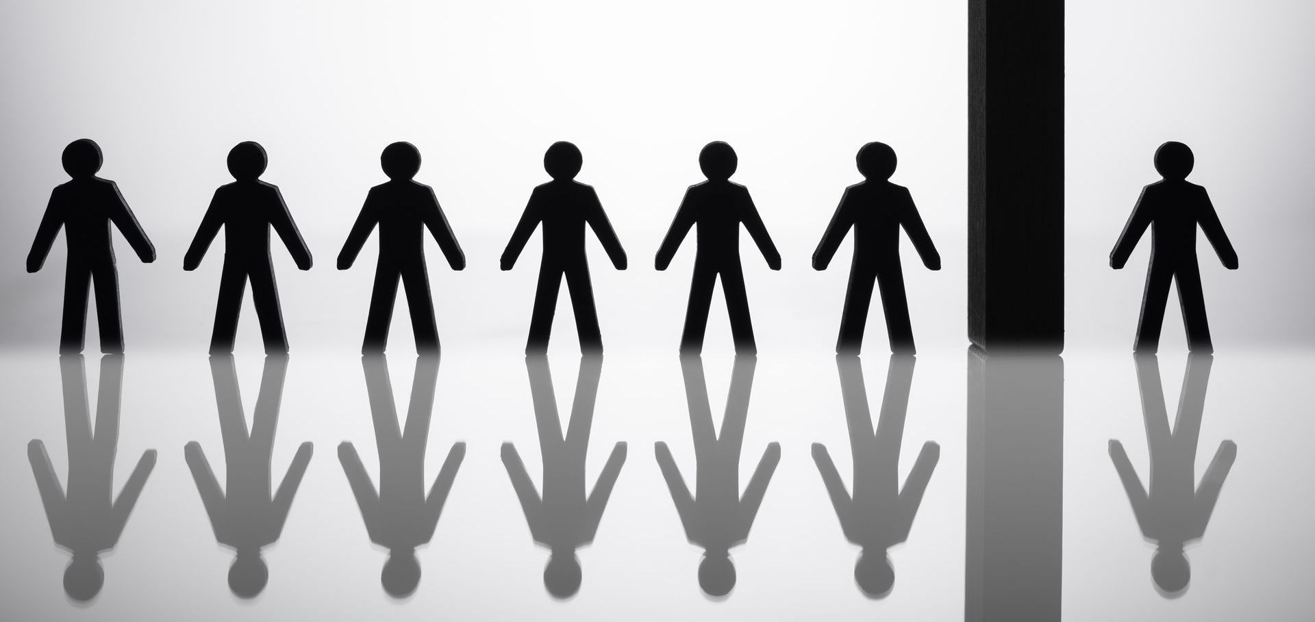 A row of people standing next to each other with arrows pointing in opposite directions.