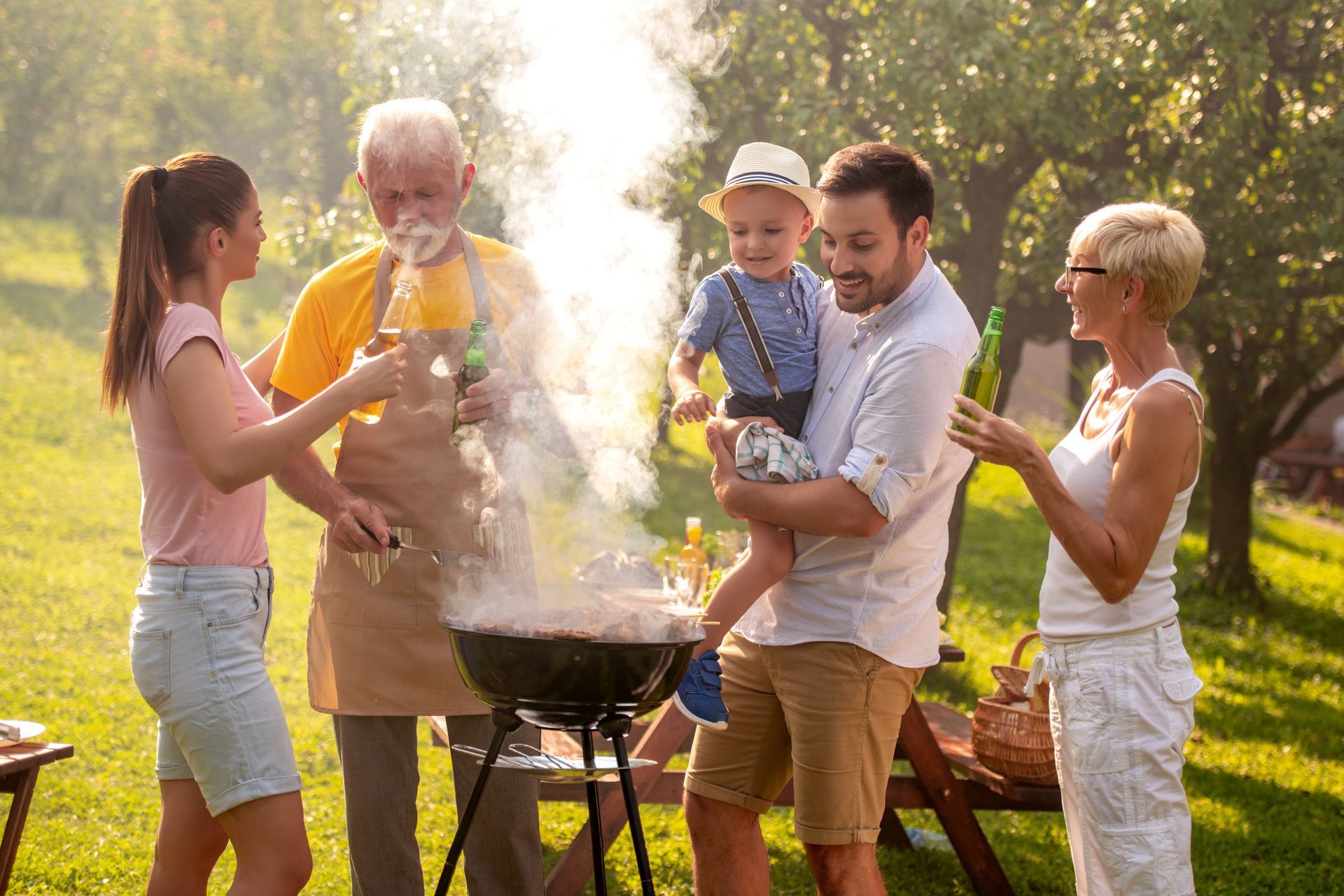 A family is having a barbecue in the park.