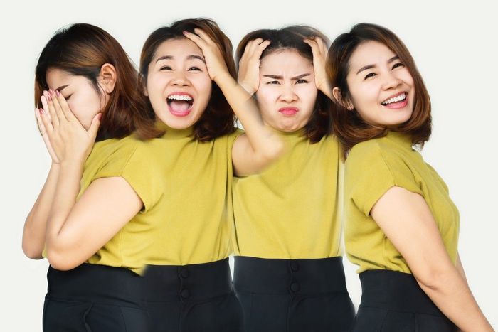 A group of women are standing next to each other and making different faces.