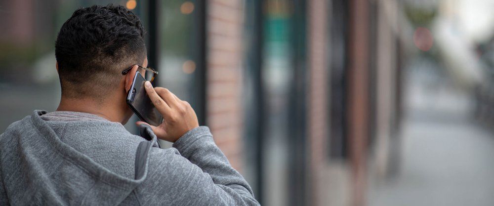 Man on phone representing the launch of the 988 mental health crisis hotline available across the United States.