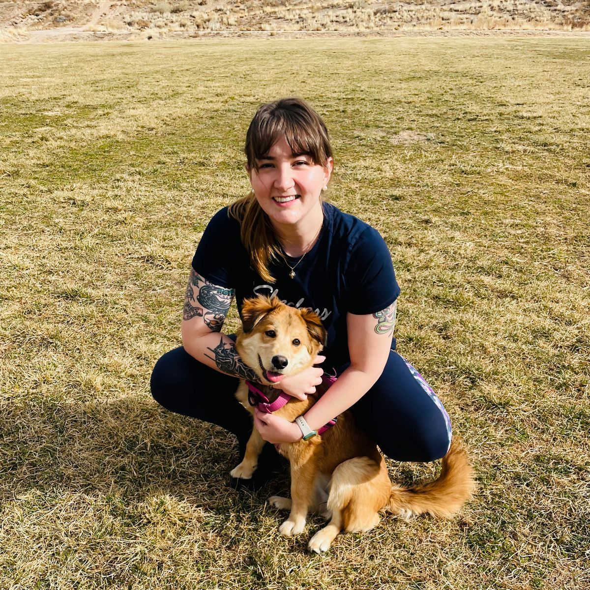Michelle Ben from Sandia Therapy and Wellness Center in Albuquerque is sitting outdoors with her pet dog.