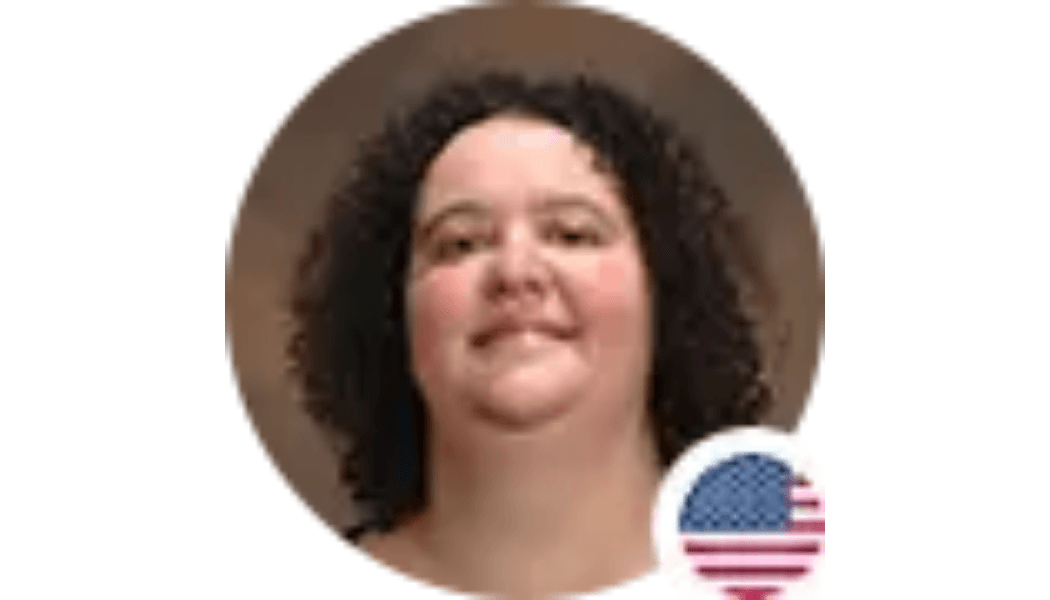 Woman with curly dark hair smiles, US flag icon.