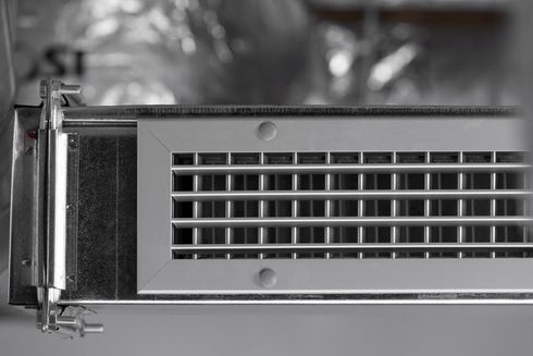 A black and white photo of a metal object with holes in it.