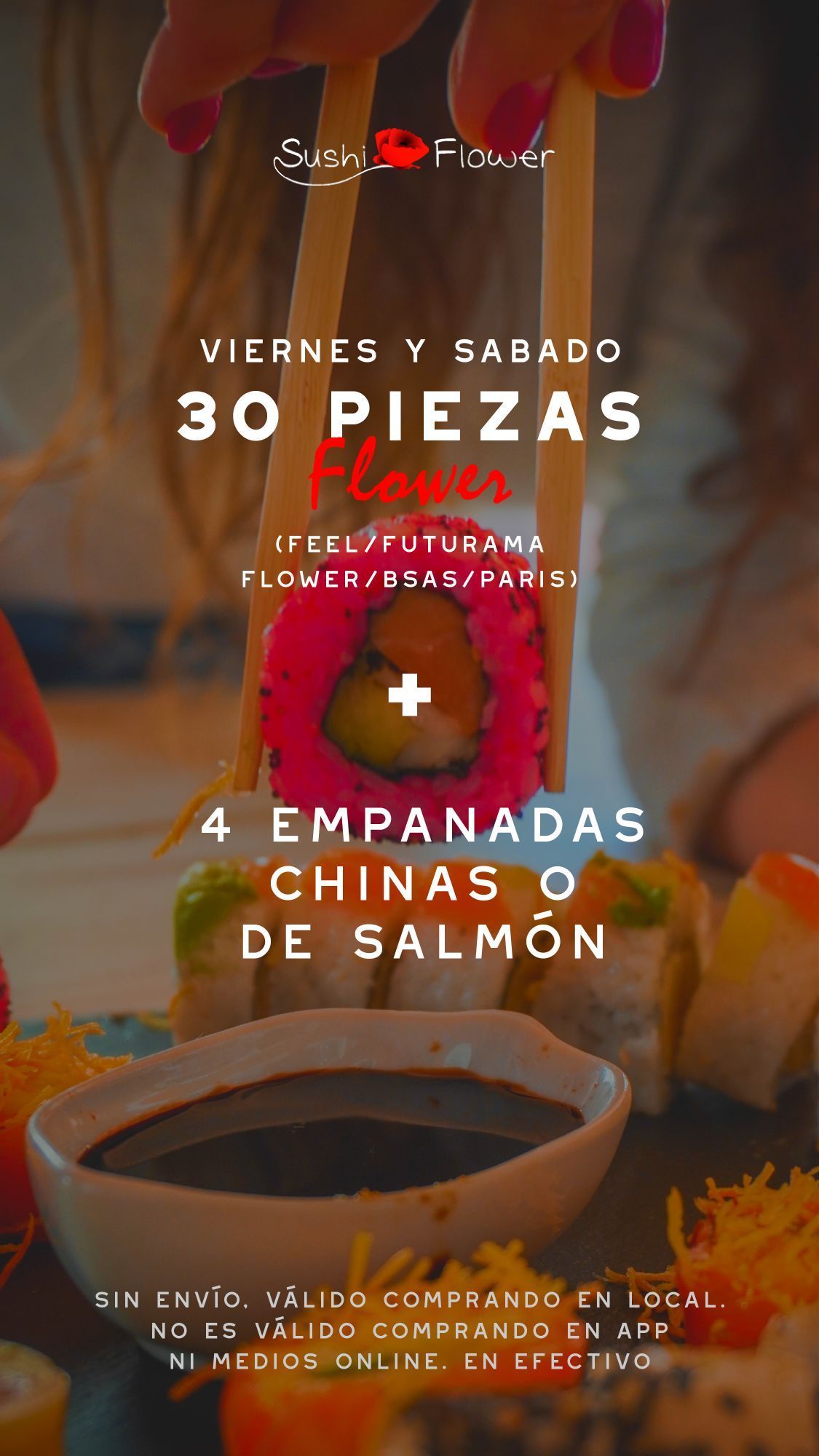 A person is holding a piece of sushi with chopsticks over a bowl of dipping sauce.